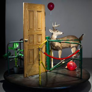 MyeongBeom Kim, Merry go round, 2017, Revolving platform, deer taxidermy,door, plant, balloons, guide rope, 240 x 240 x 280 cm